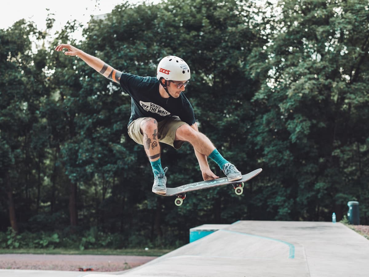 A skater grabbing their board mid-air at a skatepark